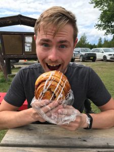 man eating cinnamon roll